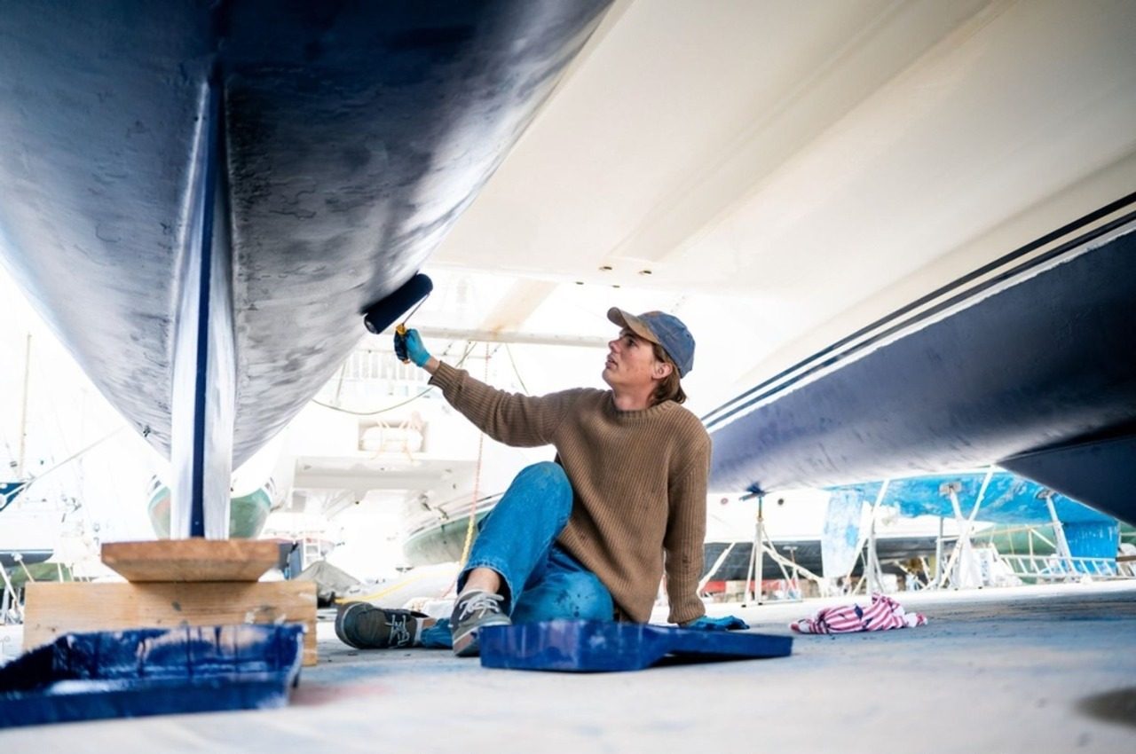 Aircraft Painting Sunshine Coast stock photo a man painting the hull of a ship with blue paint 2588258401 e1779239224921