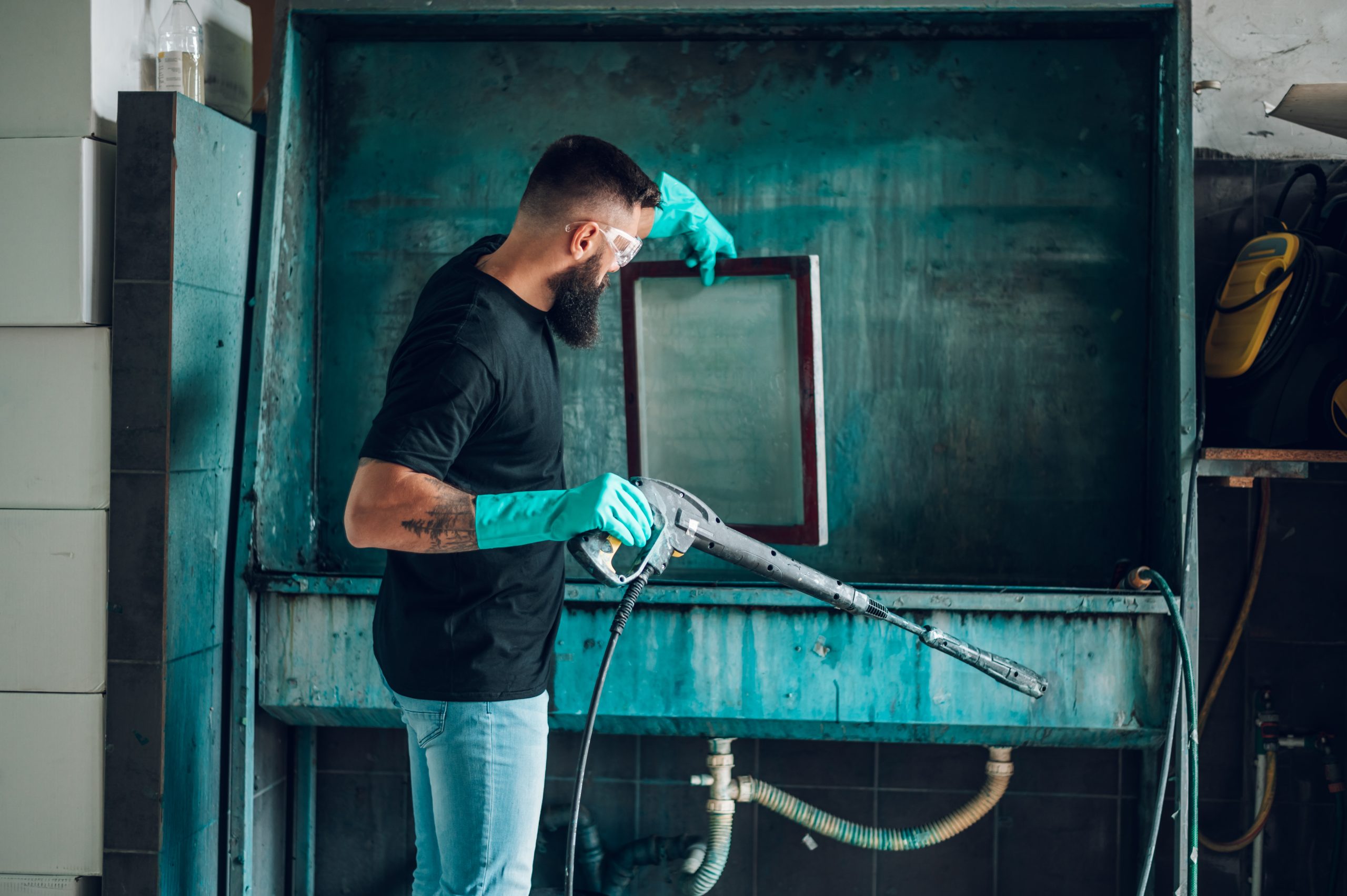 Best Abrasive Blaster male worker cleaning screen frame with water in a 2026 01 09 08 30 44 utc scaled
