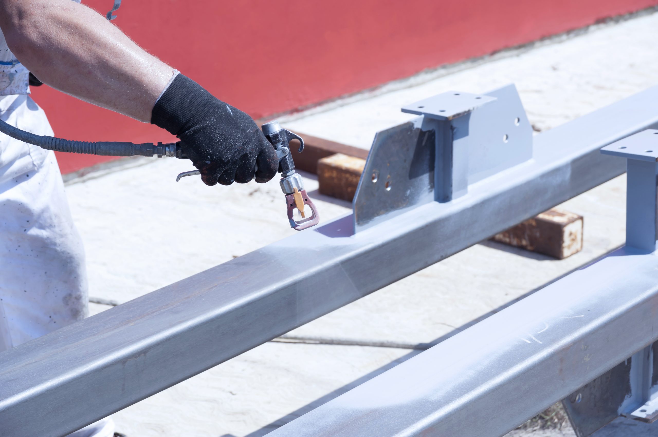 metal worker spray painting a metal structure 2026 03 17 05 07 15 utc scaled