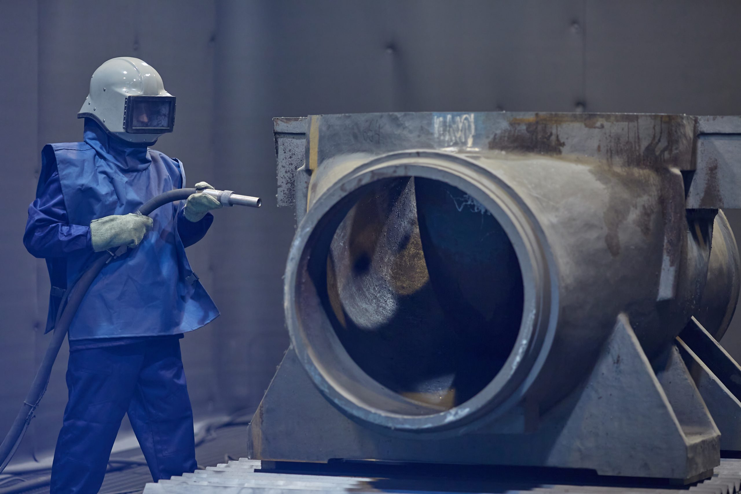 worker processes workpiece with sandblasting tool 2026 03 24 01 30 32 utc 1 scaled