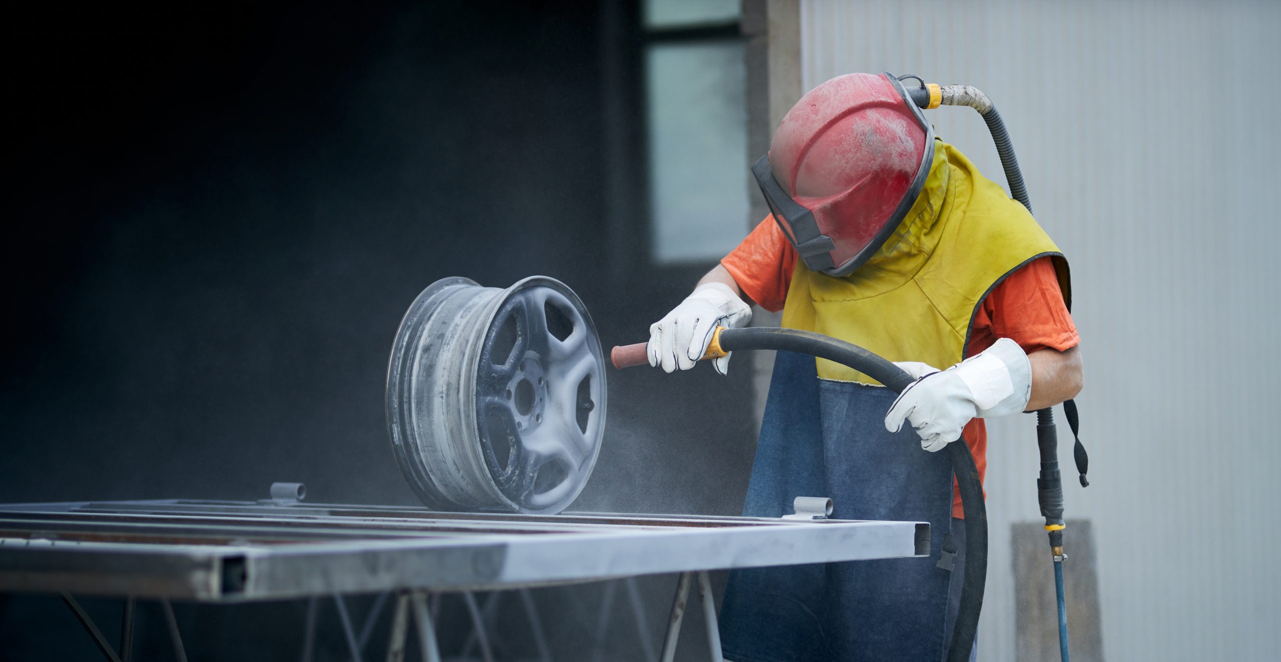 Sandblasting worker sandblasting a wheel in auto repair shop 2026 01 09 07 20 59 utc 2 scaled